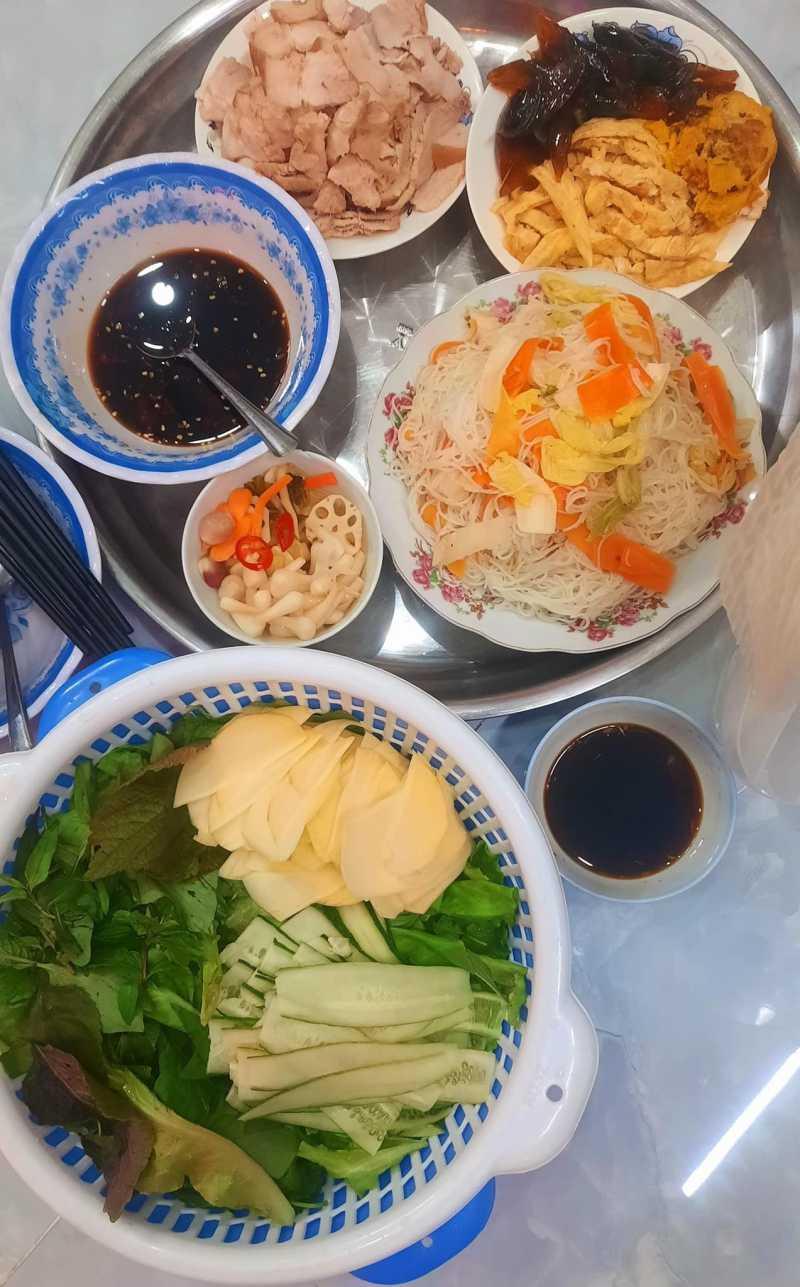 Bún xào ăn kèm rau xanh và nước tương Maggi